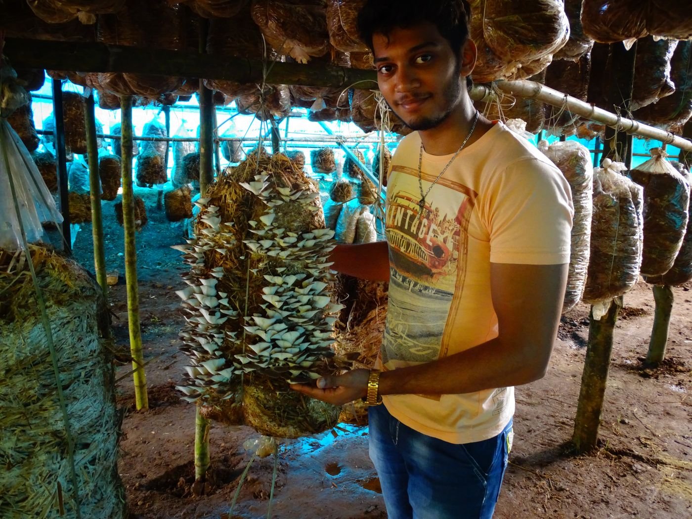 A trainee proudly holding a pink oyster harvest